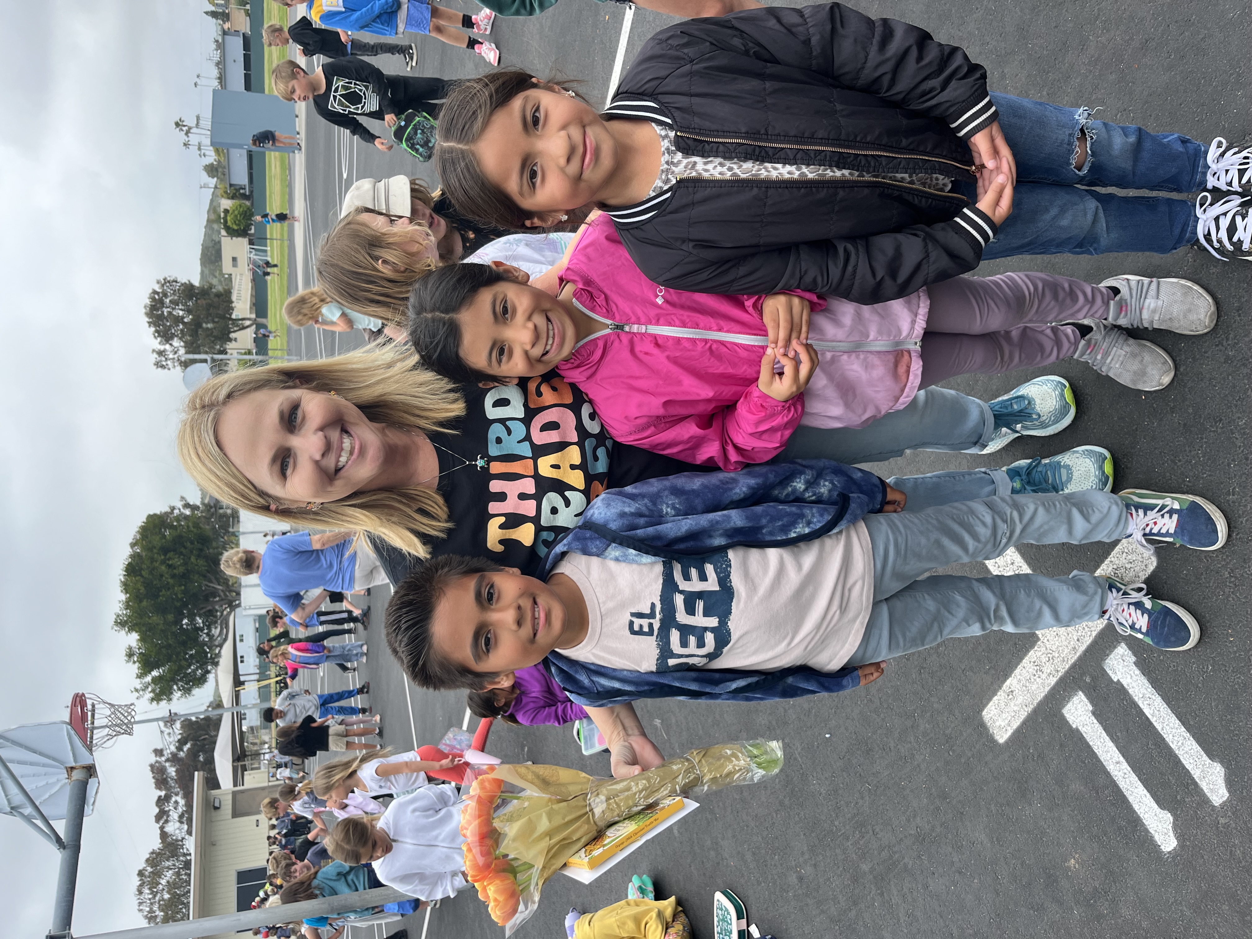 two girl smiling at each other and wearing backpacks